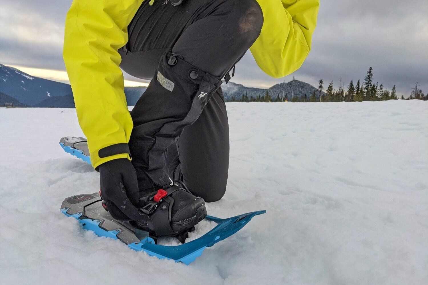 A-person-adjusting-the-bindings-on-the-MSR-Revo-Explore-Snowshoes