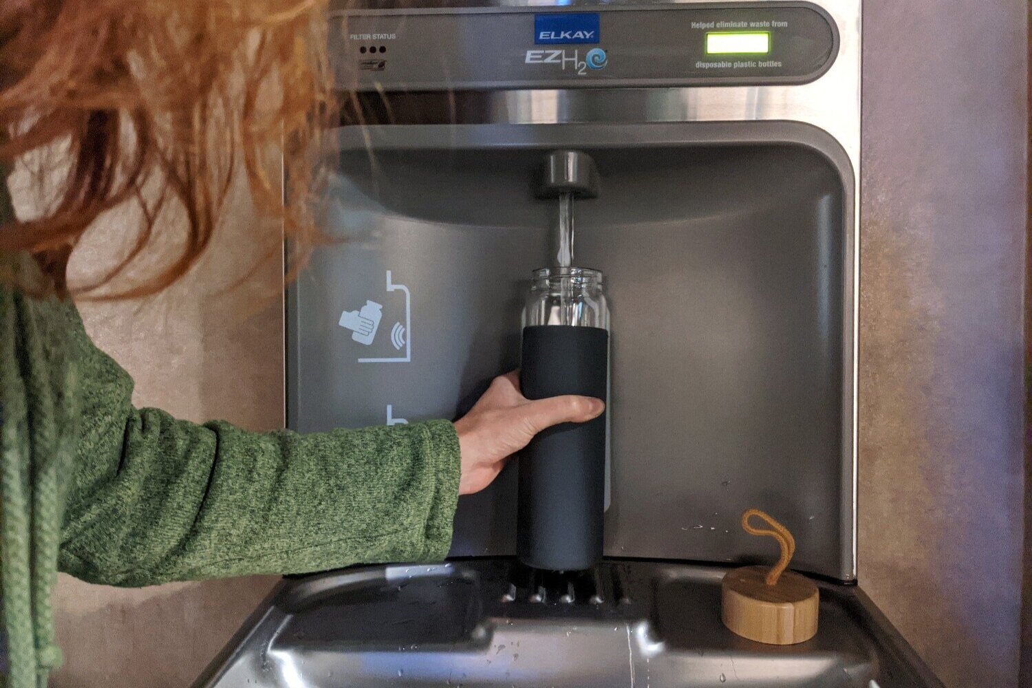 https://www.cleverhiker.com/wp-content/uploads/2023/08/A-person-filling-the-Yomious-Glass-Water-Bottle-at-a-water-fountain.jpeg