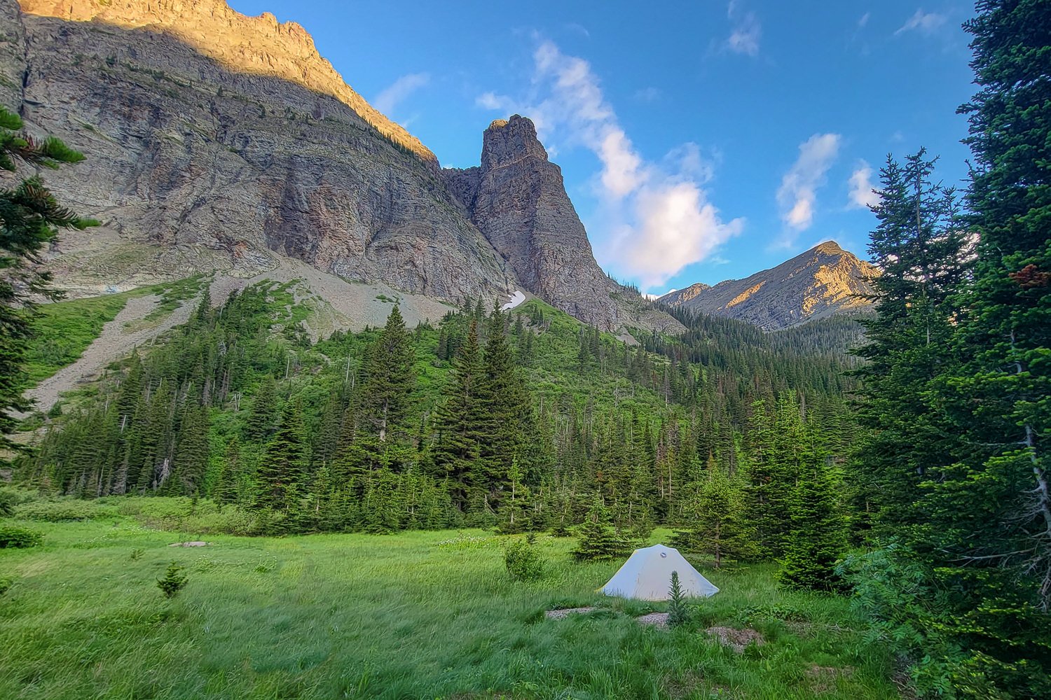 Distant view of the Big Agnes Tiger Wall UL2 pitched in front of a craggy mountain foot