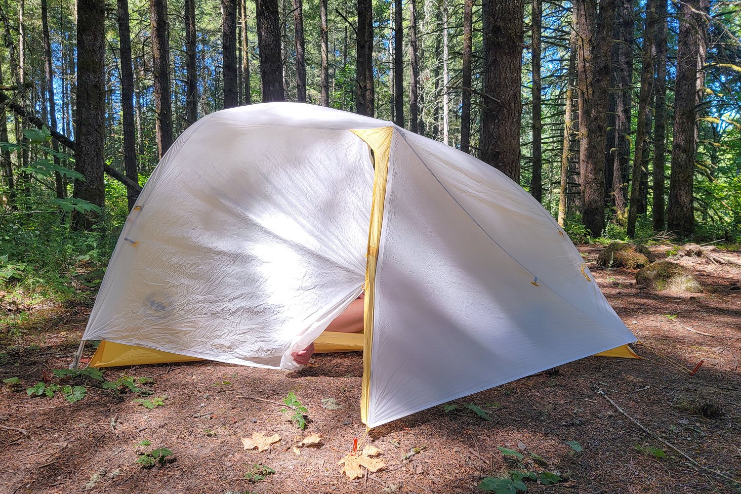 Using two hands to unzip the rainfly door on the Tiger Wall tent