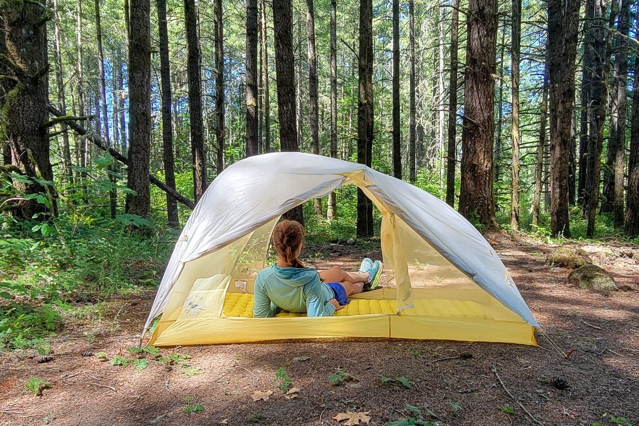 A backpacker in the Big Agnes Tiger Wall UL2 with both doors wide open