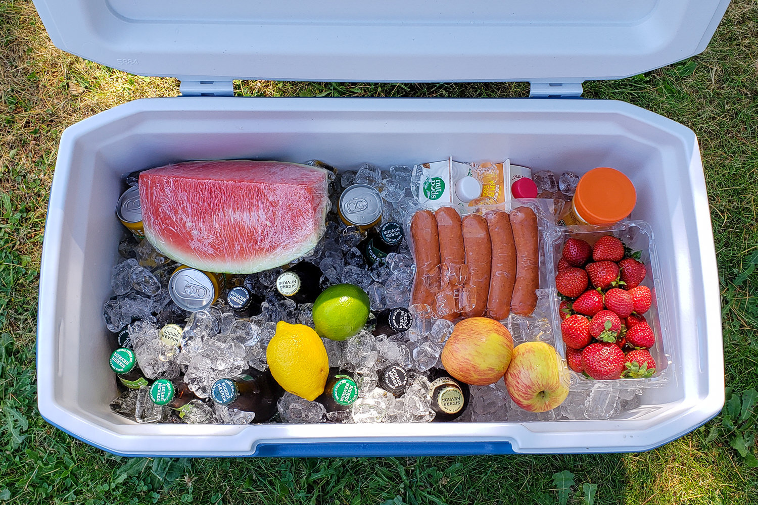 Top-down view of the Coleman 316 Series 70 Quart cooler full of ice, food, and drinks