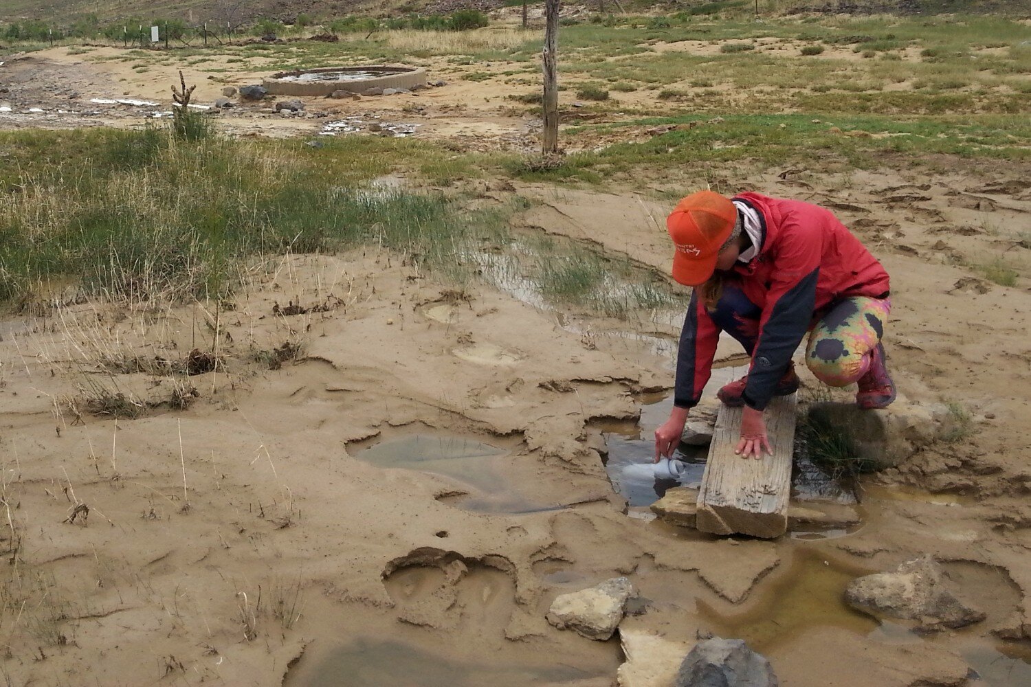 If you run into a shallow water source while backpacking, the easiest solution is to dig out a deeper pool so you can submerge your bottle for filling.