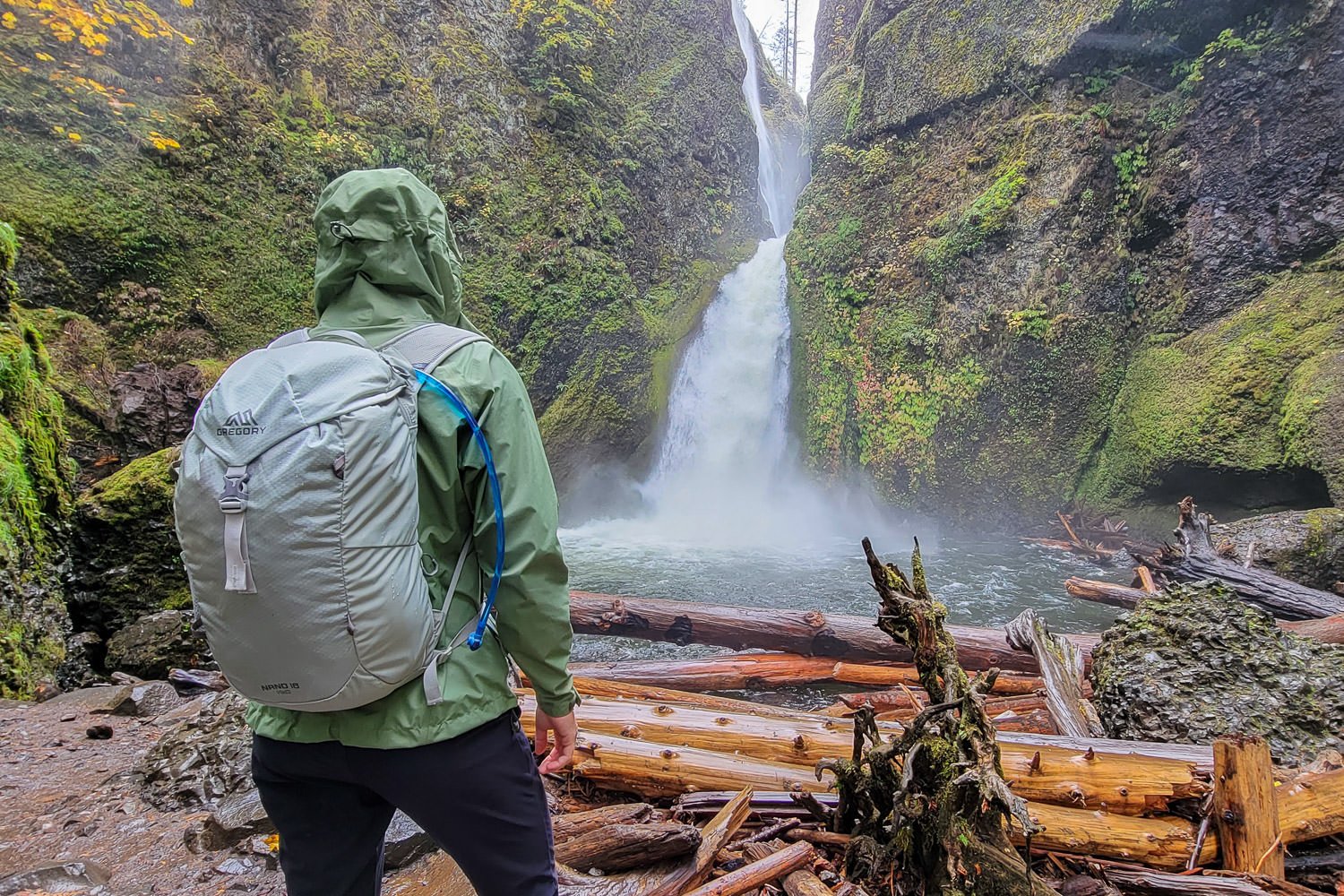 A hiker using the Gregory 3D Hydro hydration bladder on a waterfall day hike in the Gorge.