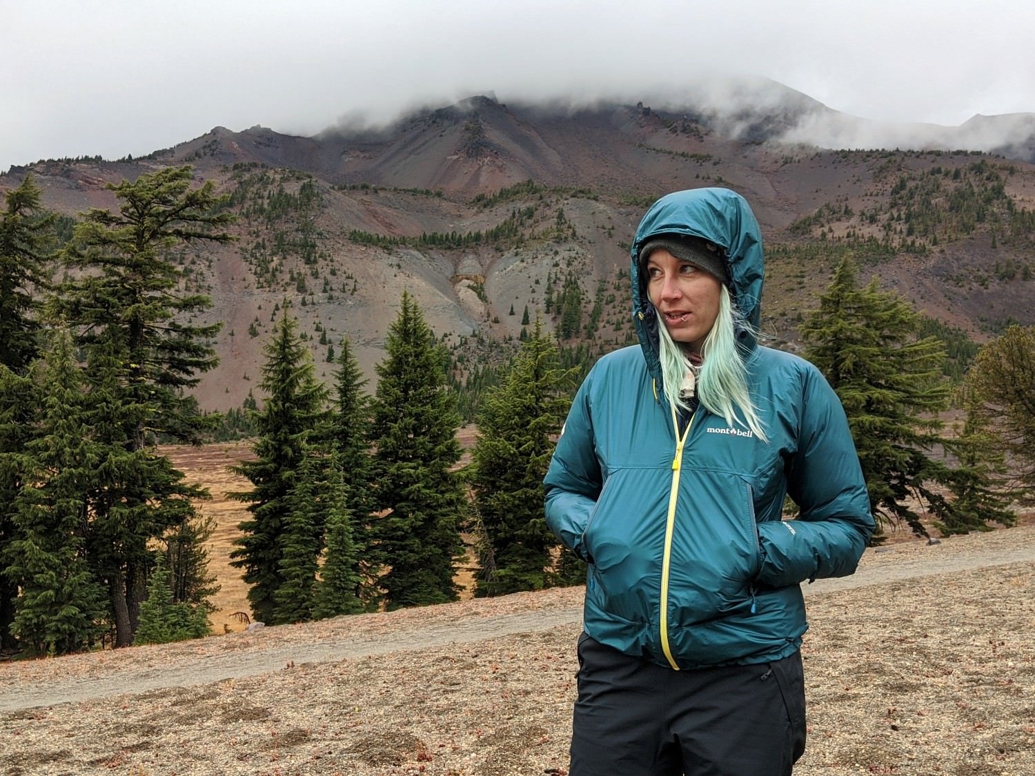 A backpacker wearing the Montbell Versalite Jacket in the Three Sisters Wilderness