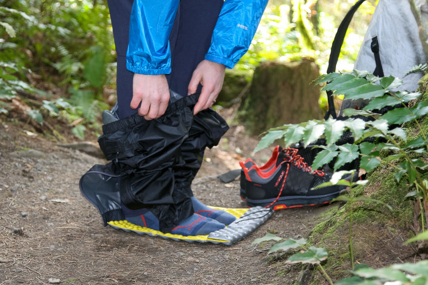Standing on a Therm-a-Rest Z-Seat Pad to put rain pants on mid-hike
