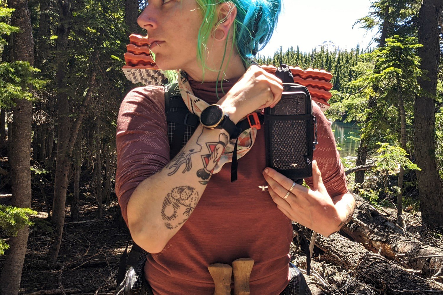 A hiker wearing a backpack with a Hyperlite Mountain Gear Shoulder Pocket attached