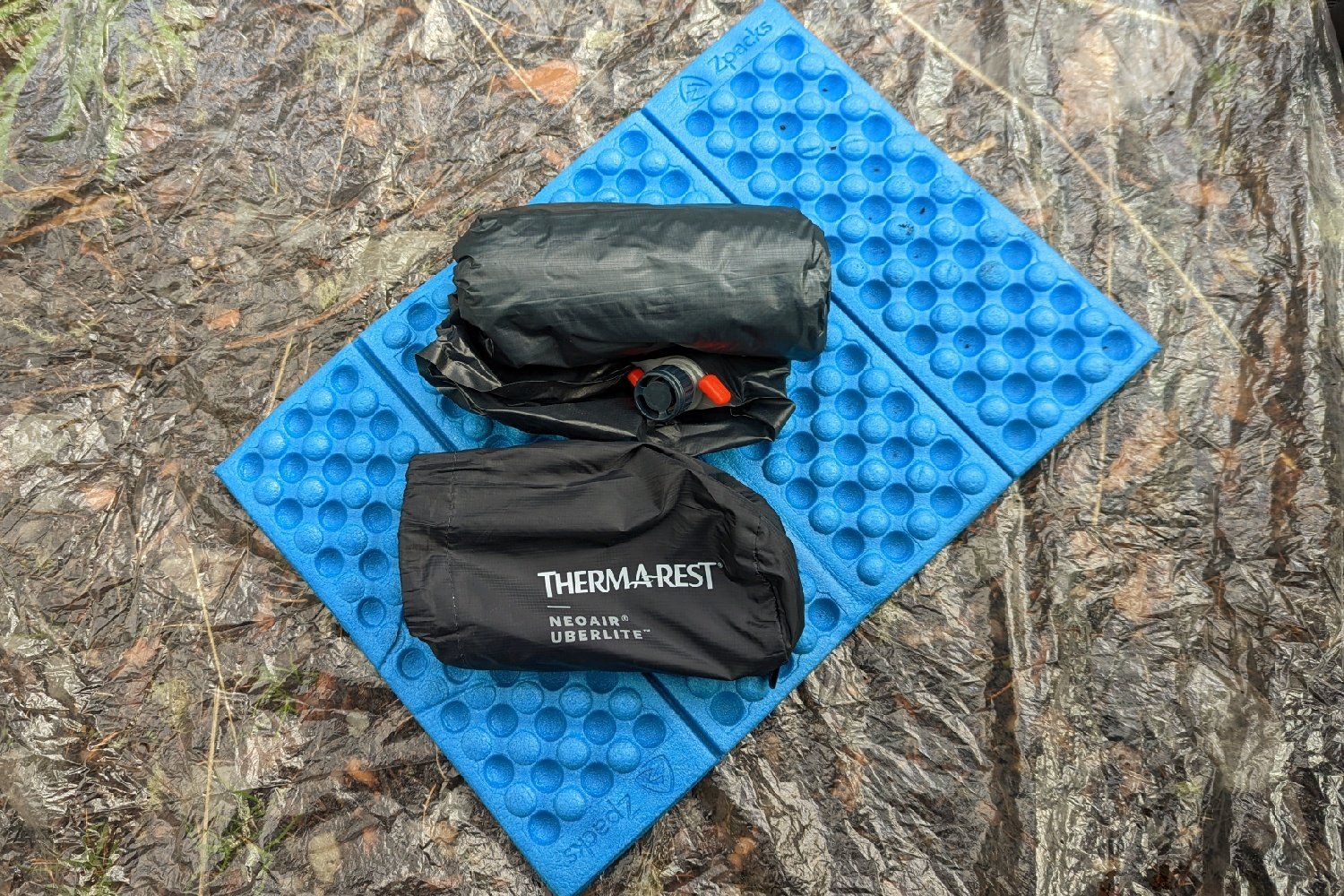 A Therm-a-Rest Uberlite sitting next to its stuff sack on a sit pad