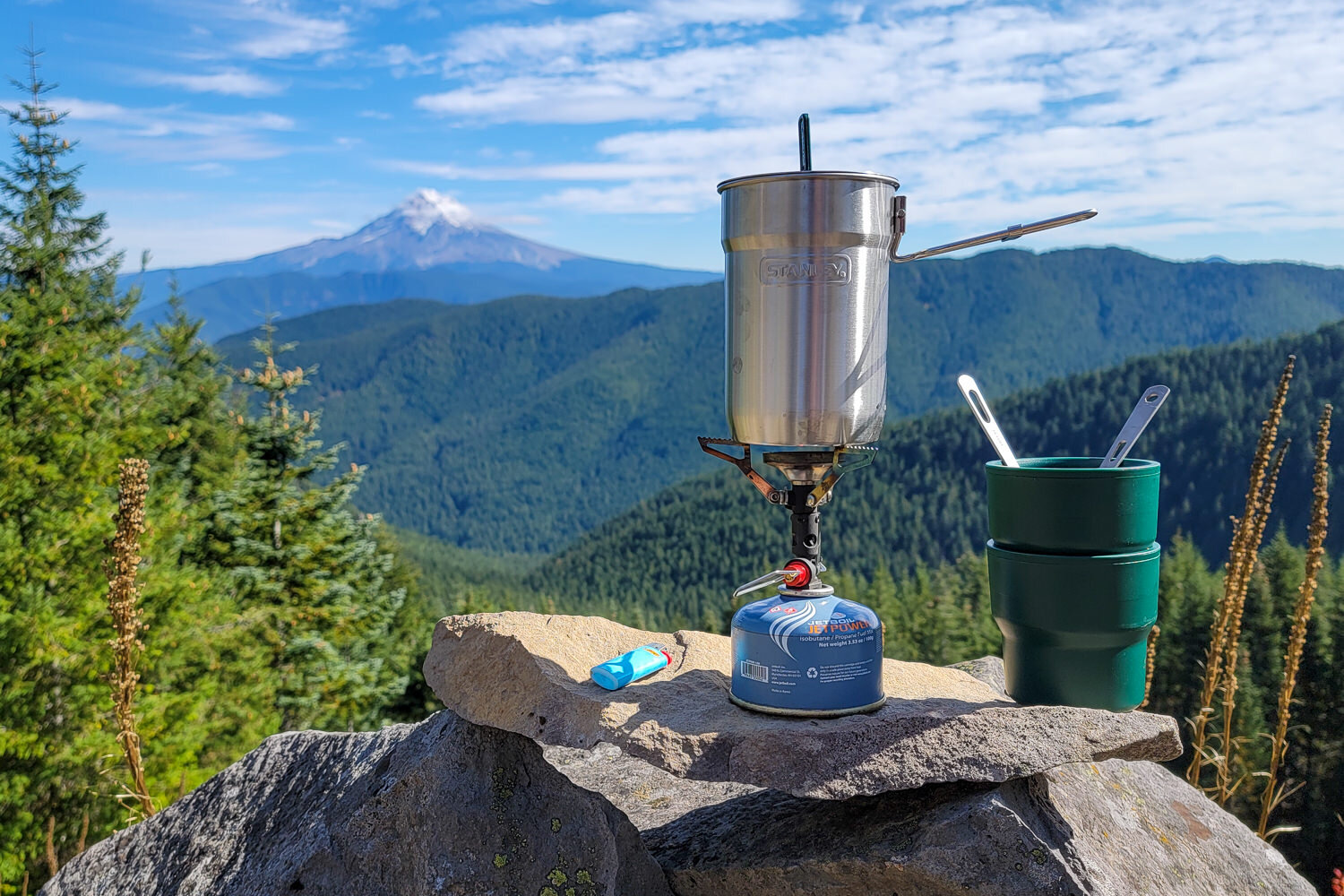 https://www.cleverhiker.com/wp-content/uploads/2023/08/The-Stanley-Adventure-Nesting-Two-Cup-Cook-Set-in-front-of-a-mountain-view.jpeg