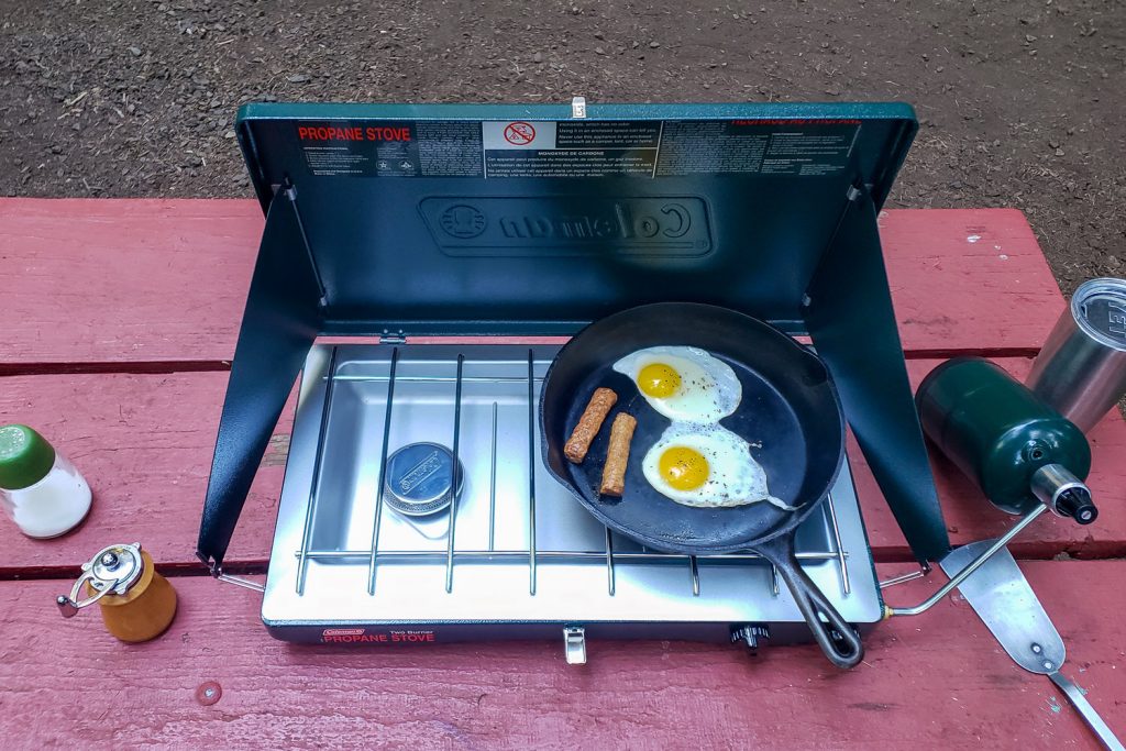 Eggs and sausage in the Lodge cast iron skillet on the Coleman Classic camping stove