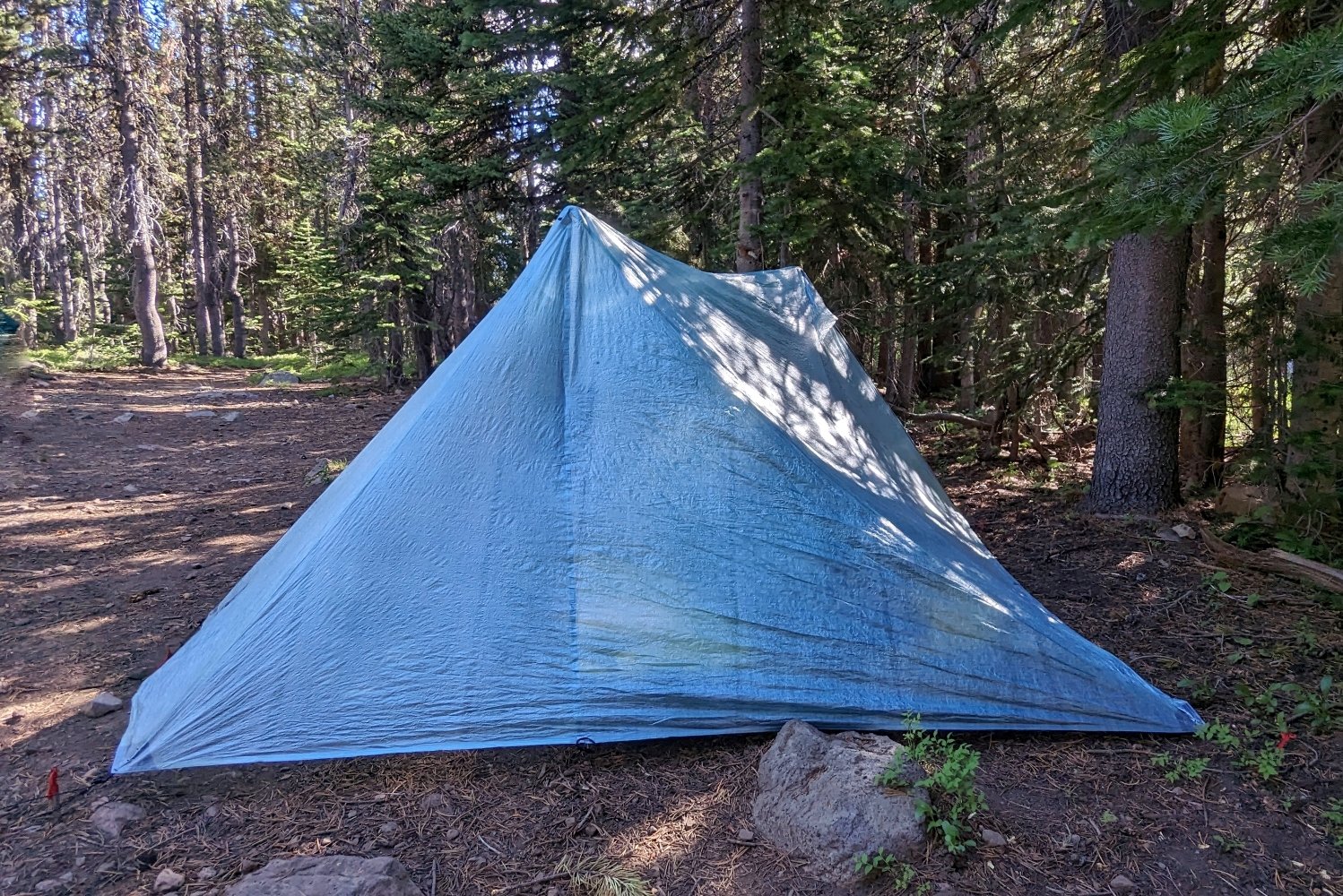 The Durston X-Mid 2 Pro tent set up in a campsite. The view is showing the two off-set peak of the tent