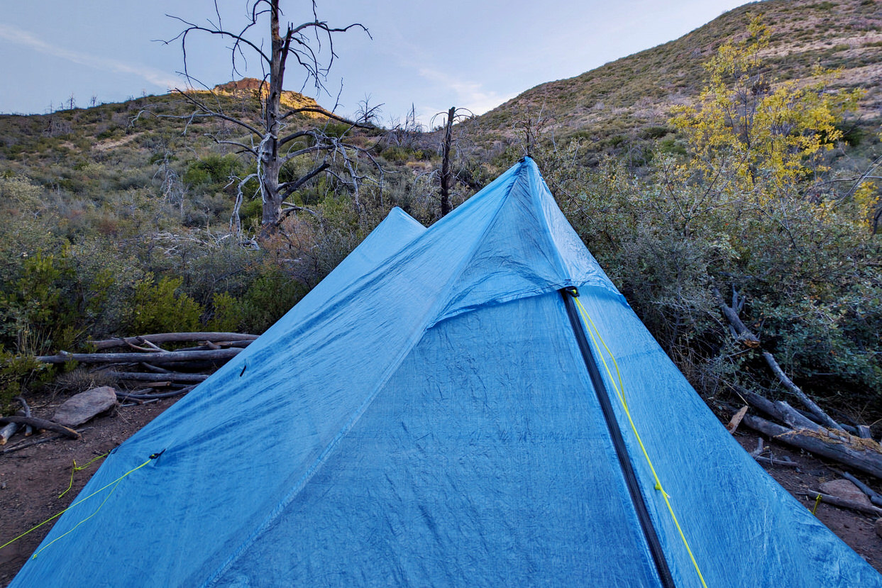 the top peak with ventilation view of the Zpacks Duplex Zip tent with mountains and blue sky in the background