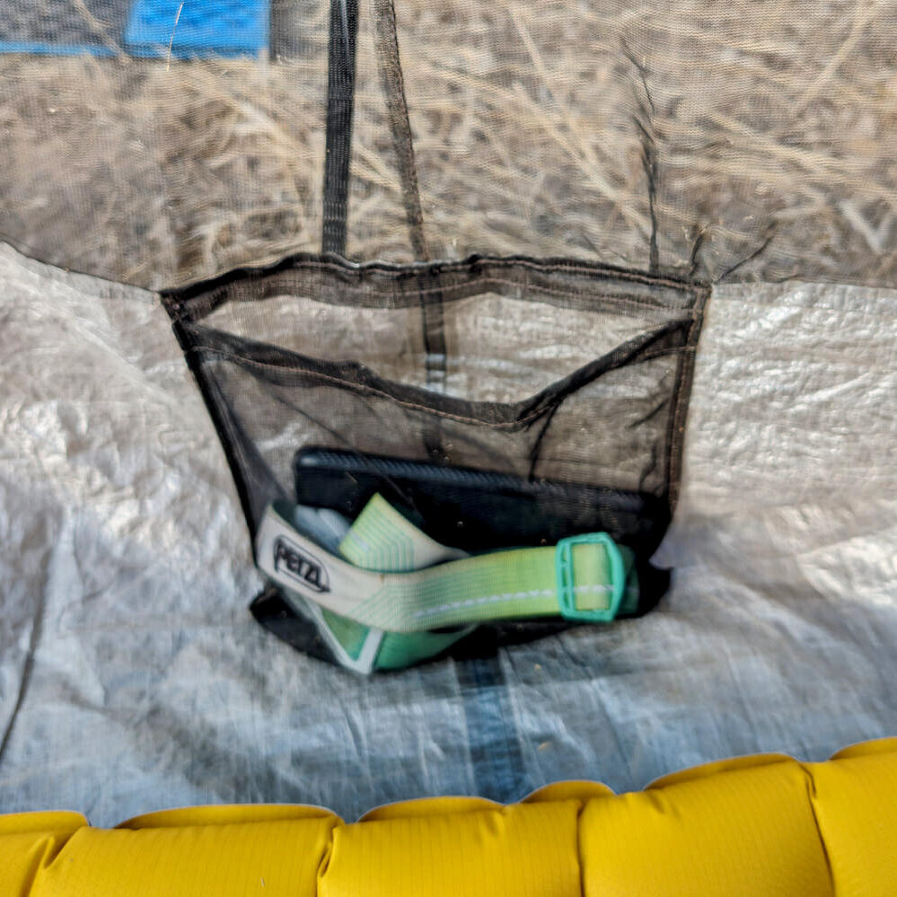 An interior shot of a pocket in the Zpacks Duplex Zip tent with a headlamp inside the pocket
