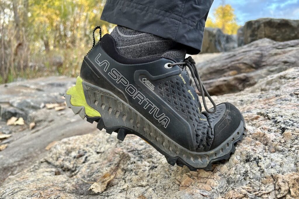 Closeup of a hiker bending the sole of the La Sportiva Spire GTX hiking shoe on a steep incline
