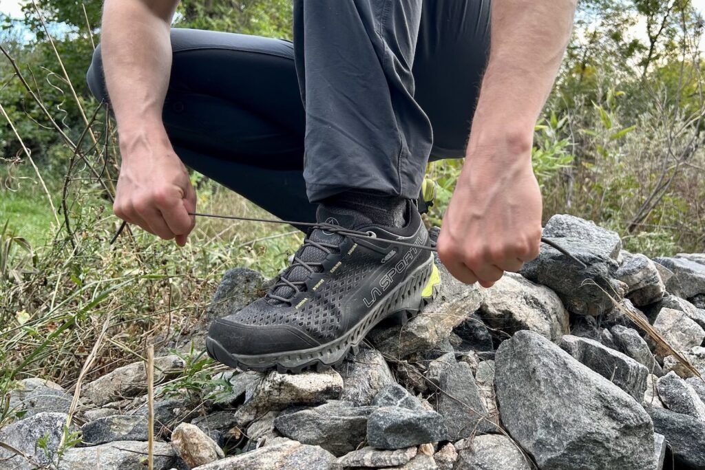 Closeup of a hiker tying the La Sportiva Spire GTX shoelaces