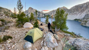 The NEMO Hornet OSMO 2 and Big Agnes Tiger Wall 2 backpacking tents pitched in a campsite surrounded by granite peaks in the Sawtooth Mountains