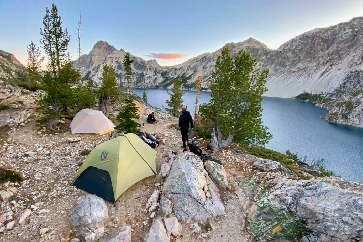 The NEMO Hornet OSMO 2 and Big Agnes Tiger Wall 2 backpacking tents pitched in a campsite surrounded by granite peaks in the Sawtooth Mountains