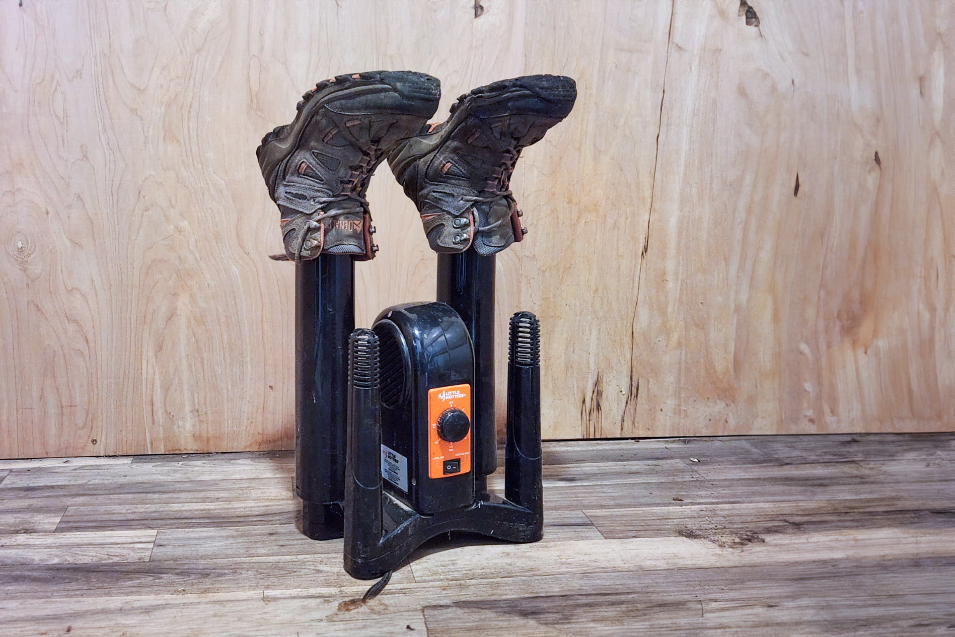 A pair of hiking boots on a boot drier