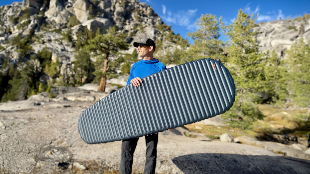 A backpacker holding the Therm-a-Rest NeoAir UberLite in Yosemite National Park