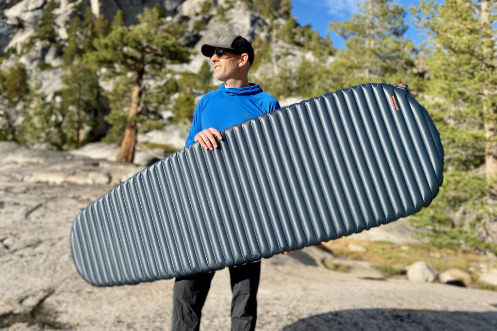 A backpacker holding the Therm-a-Rest NeoAir UberLite in Yosemite National Park