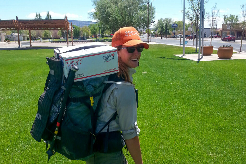 A CDT thru hiker with a resupply box