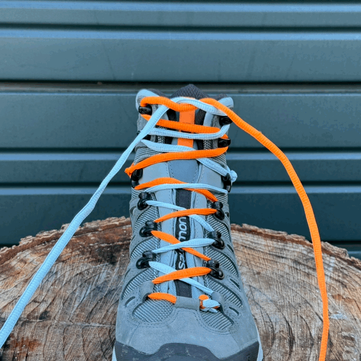 Animated photo showing dual colored shoelaces tying a standard knot on the Salomon Quest GTX hiking boots