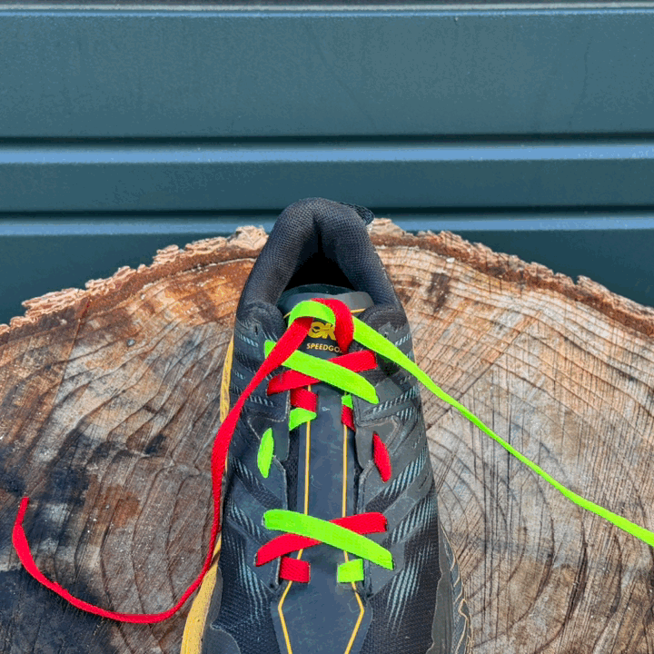 Animated photo of dual-colored shoelaces demonstrating how to tie and surgeon's knot on the women's HOKA Speedgoat trail running shoes