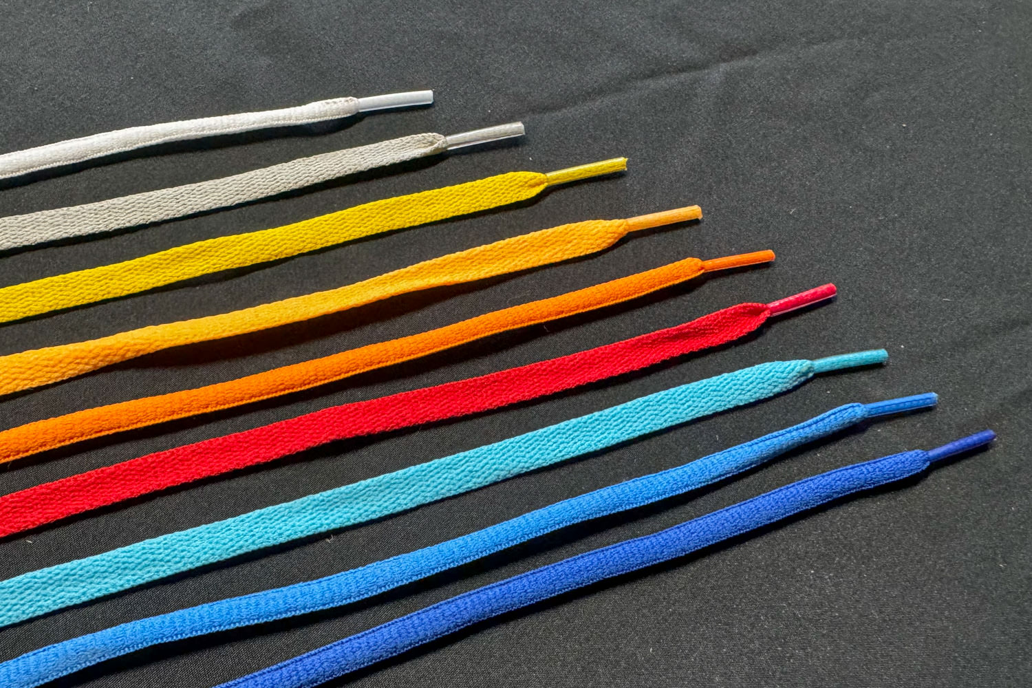 colorful flat and round shoelaces on a black background