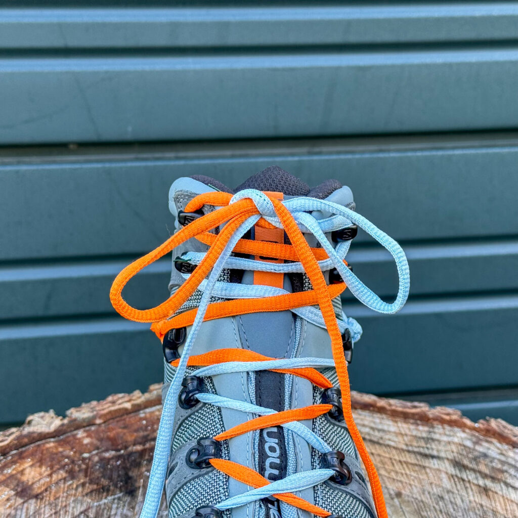 Dual colored shoelaces demonstrating how to tie a standard knot on the Salomon Quest GTX hiking boots