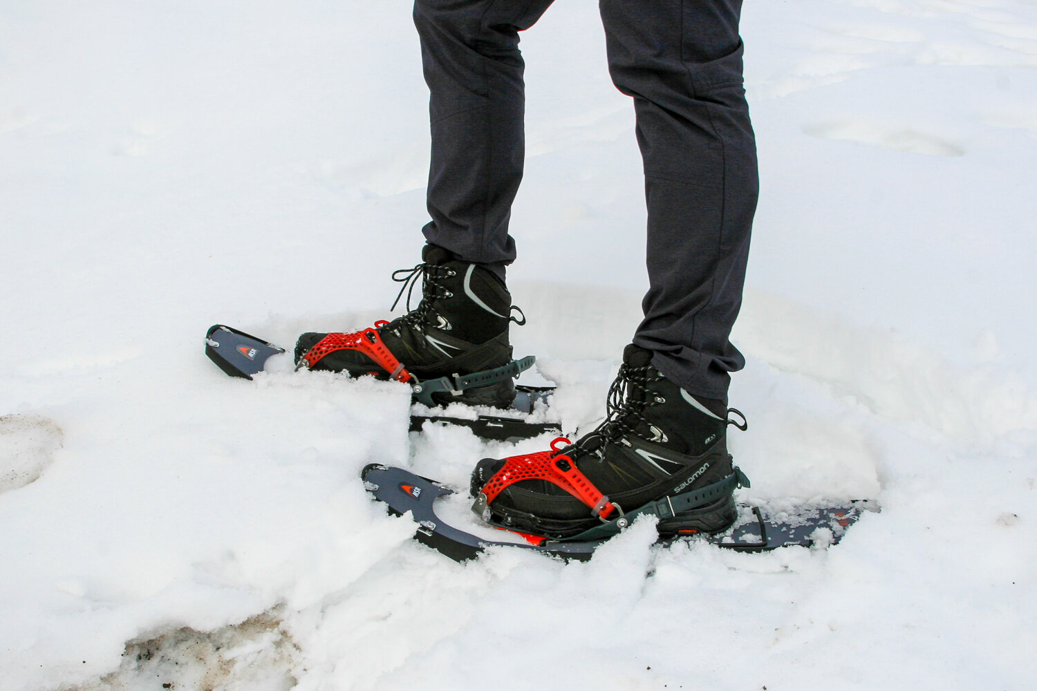 image of a hiker wearing snowshoes on snow.