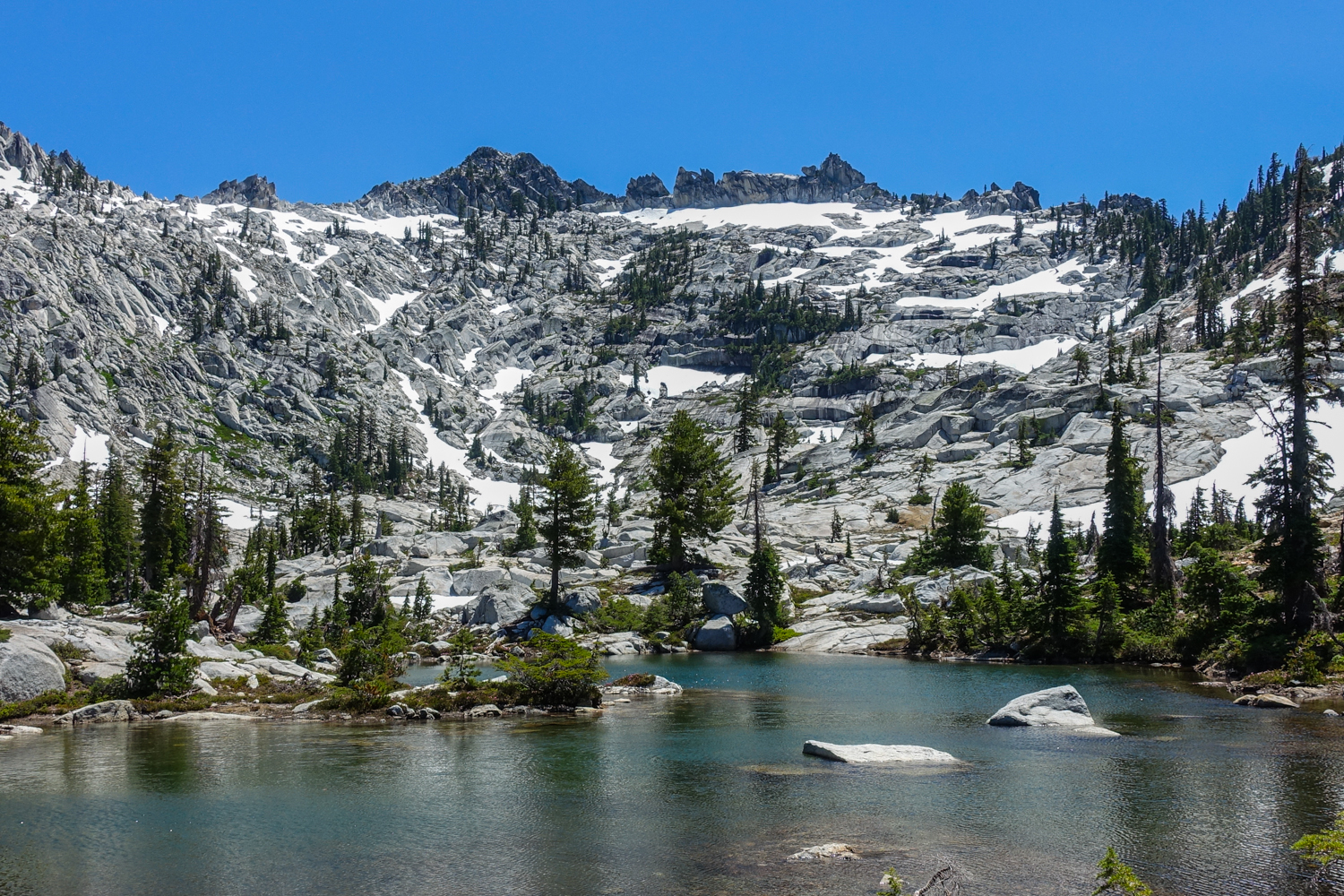 alpine lake in the snow spotted trinity alps