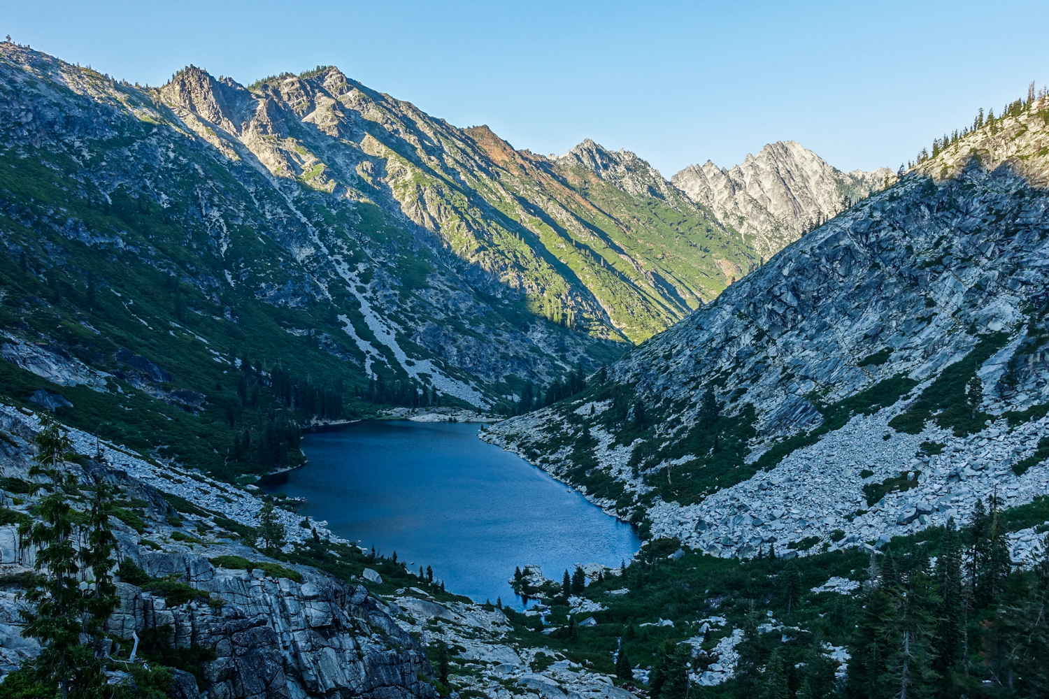 view from above a shaded alpine lake in the trinity alps