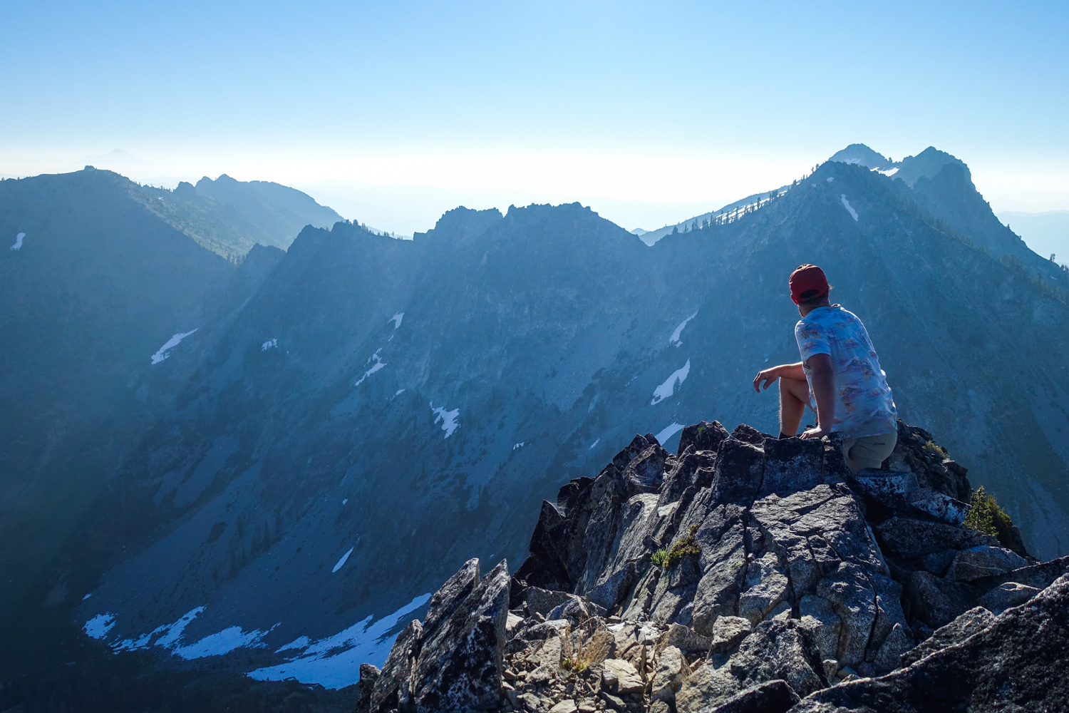 backpacker looking out on a view of the trinity alps in california