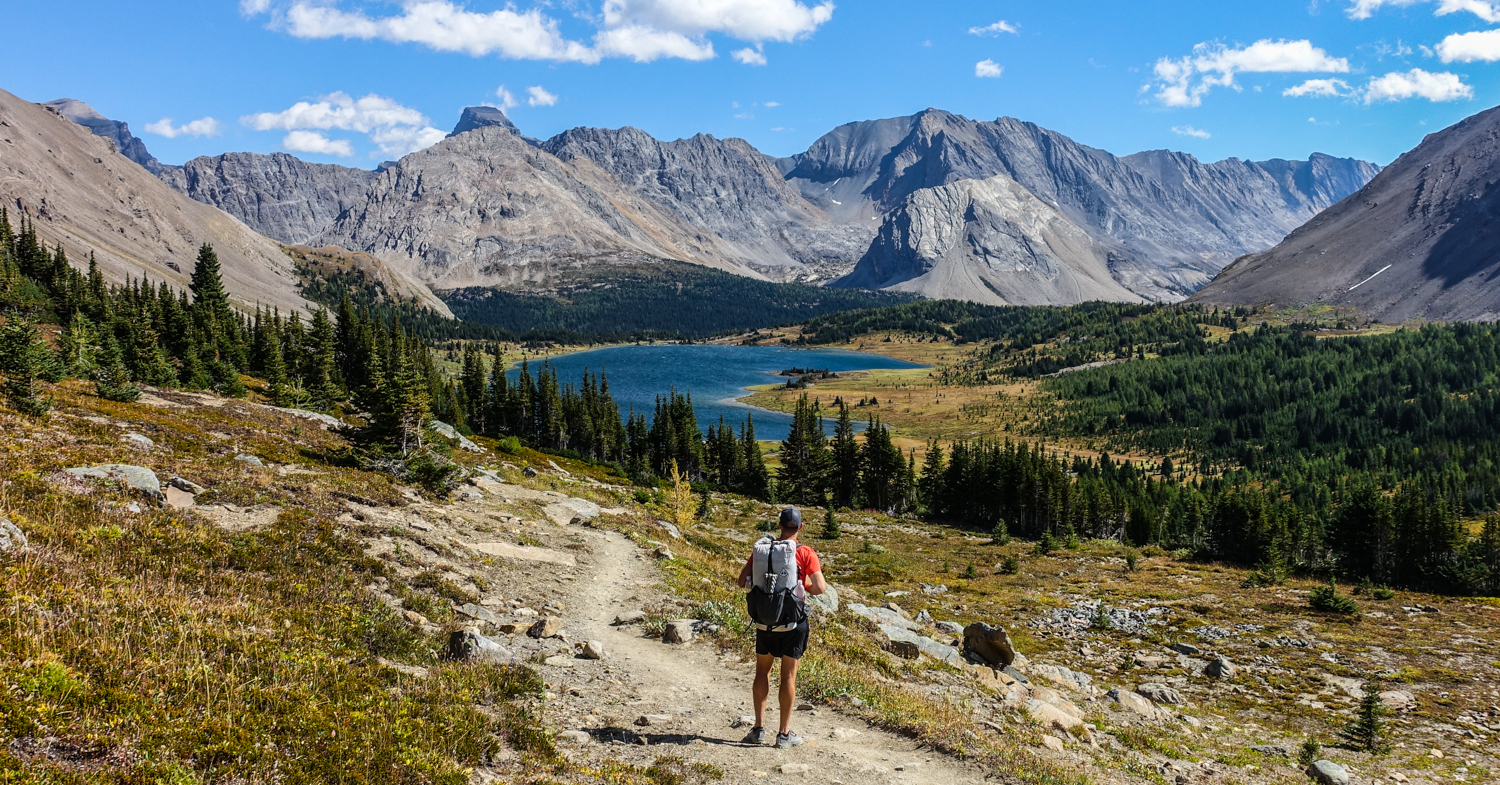 backpacker in banff national park on the sawback trail