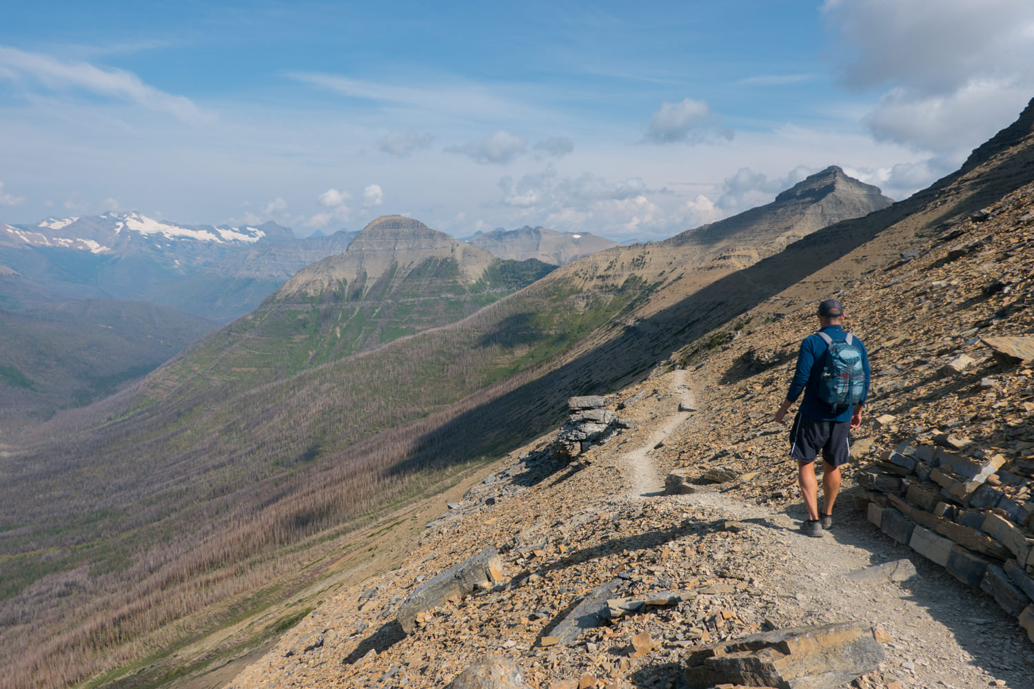 hiker in glacier national park on a high alpine rocky route