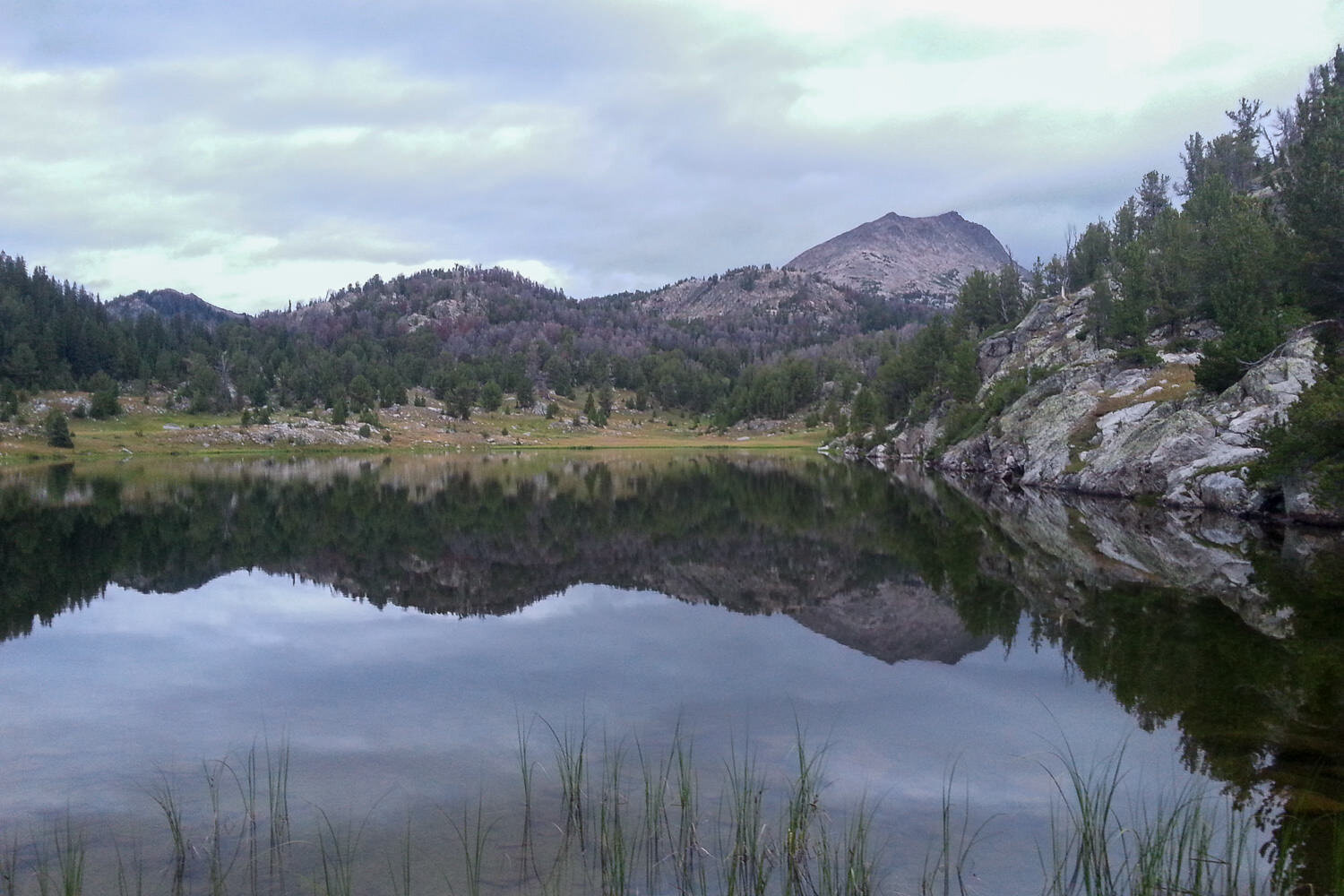 still alpine lake reflecting the mountains on the CDT