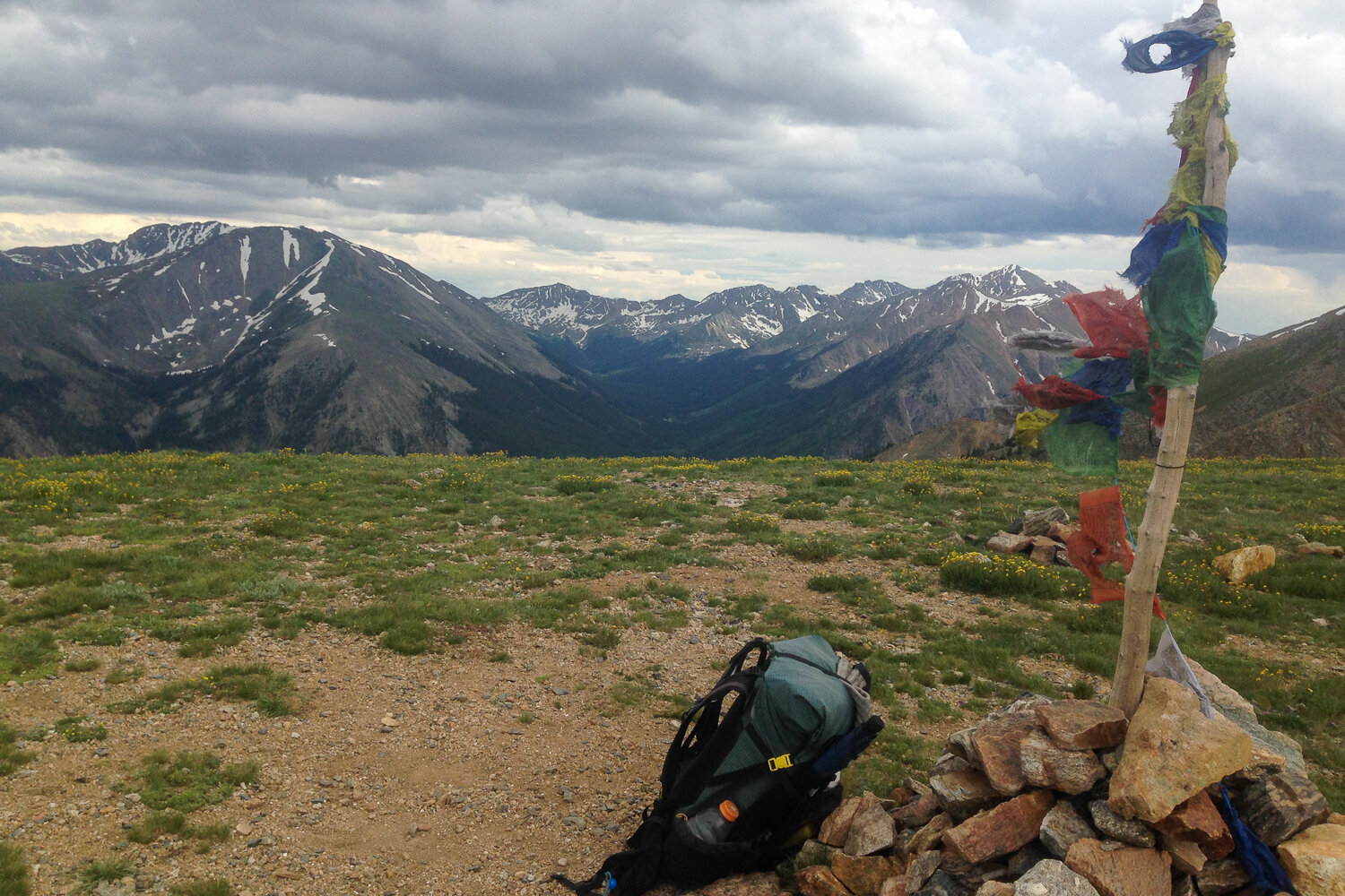 rock cairn and prayer flags mark the trail on the CDT