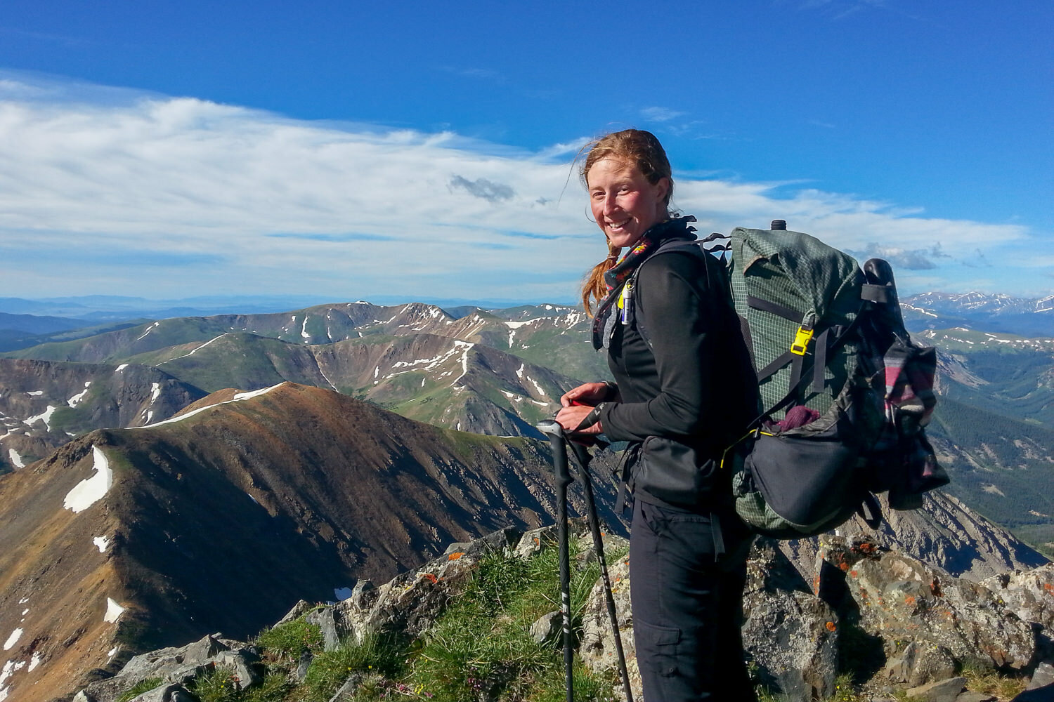 CDT thru-hiker backpacking on high alpine ridgeline.