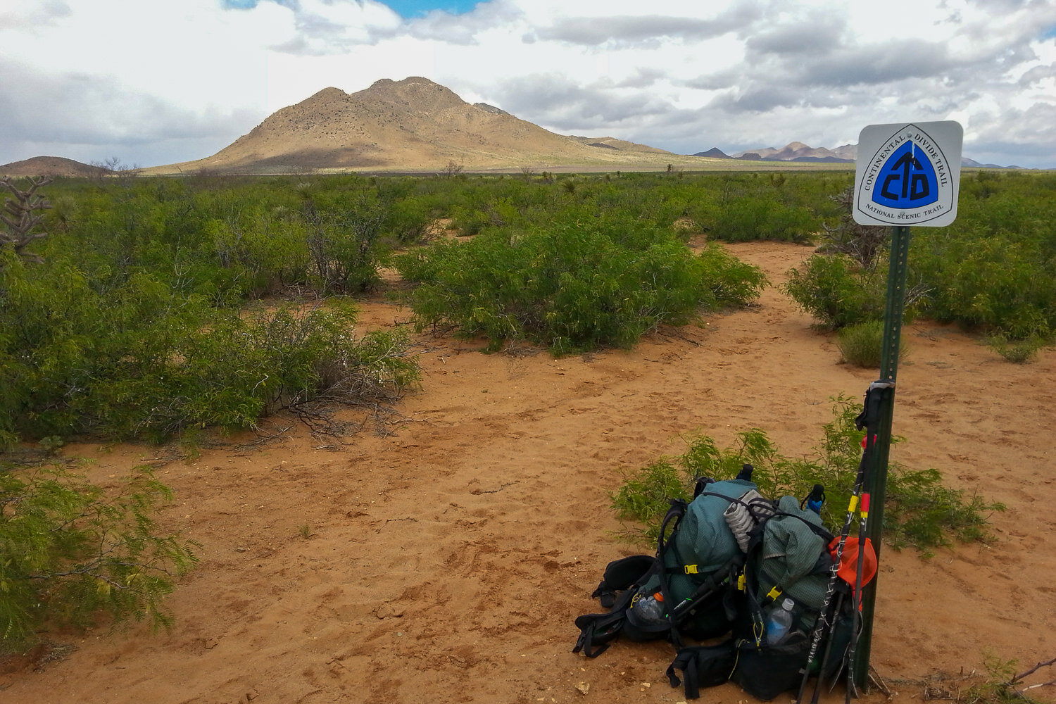 continental divide trail blaze marking the trail with a loaded backpack for the thru-hike