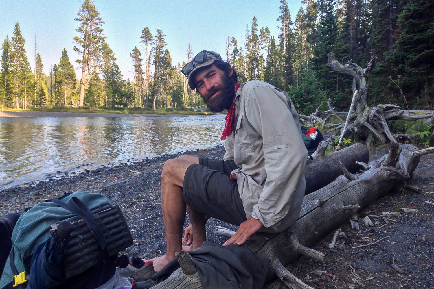 CDT thru-hiker stopping at a lake to have break and maybe swim, or at least take the boots off.