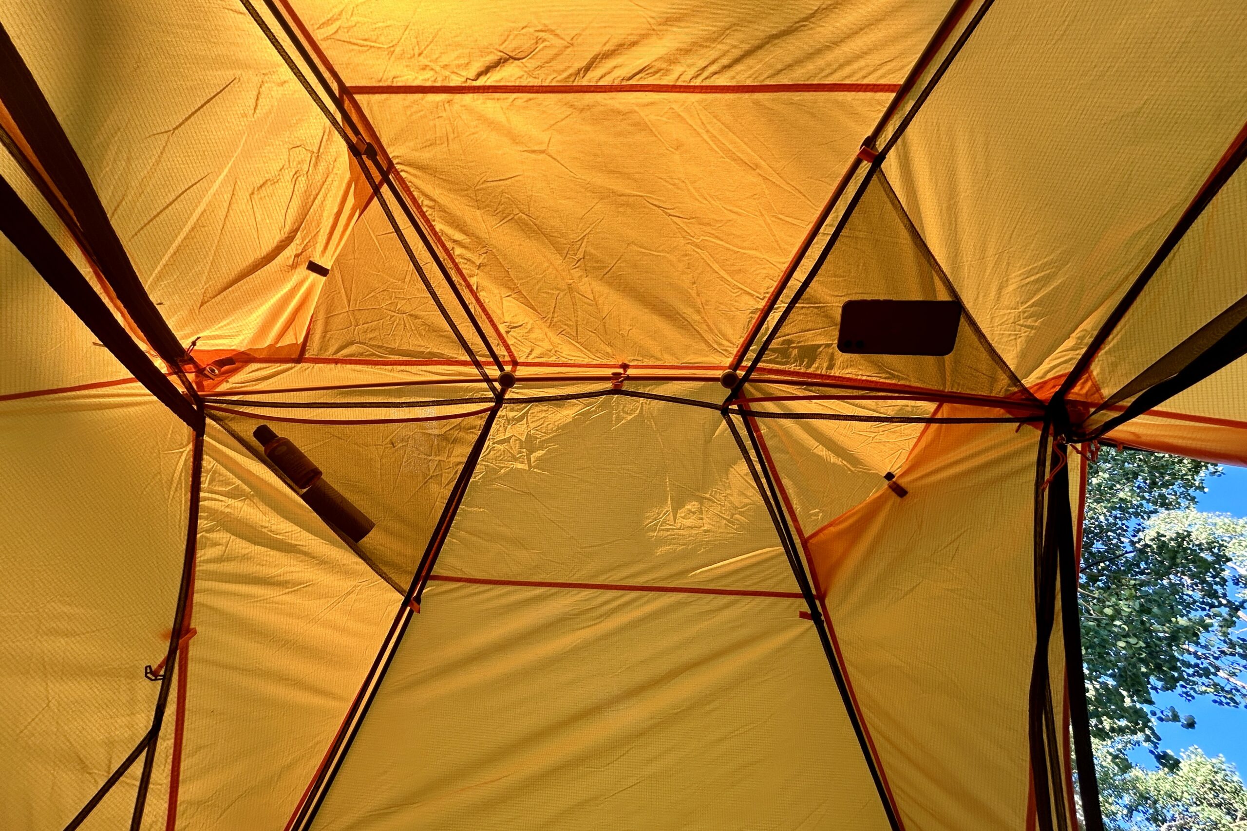 The ceiling configuration of a yellow tent.