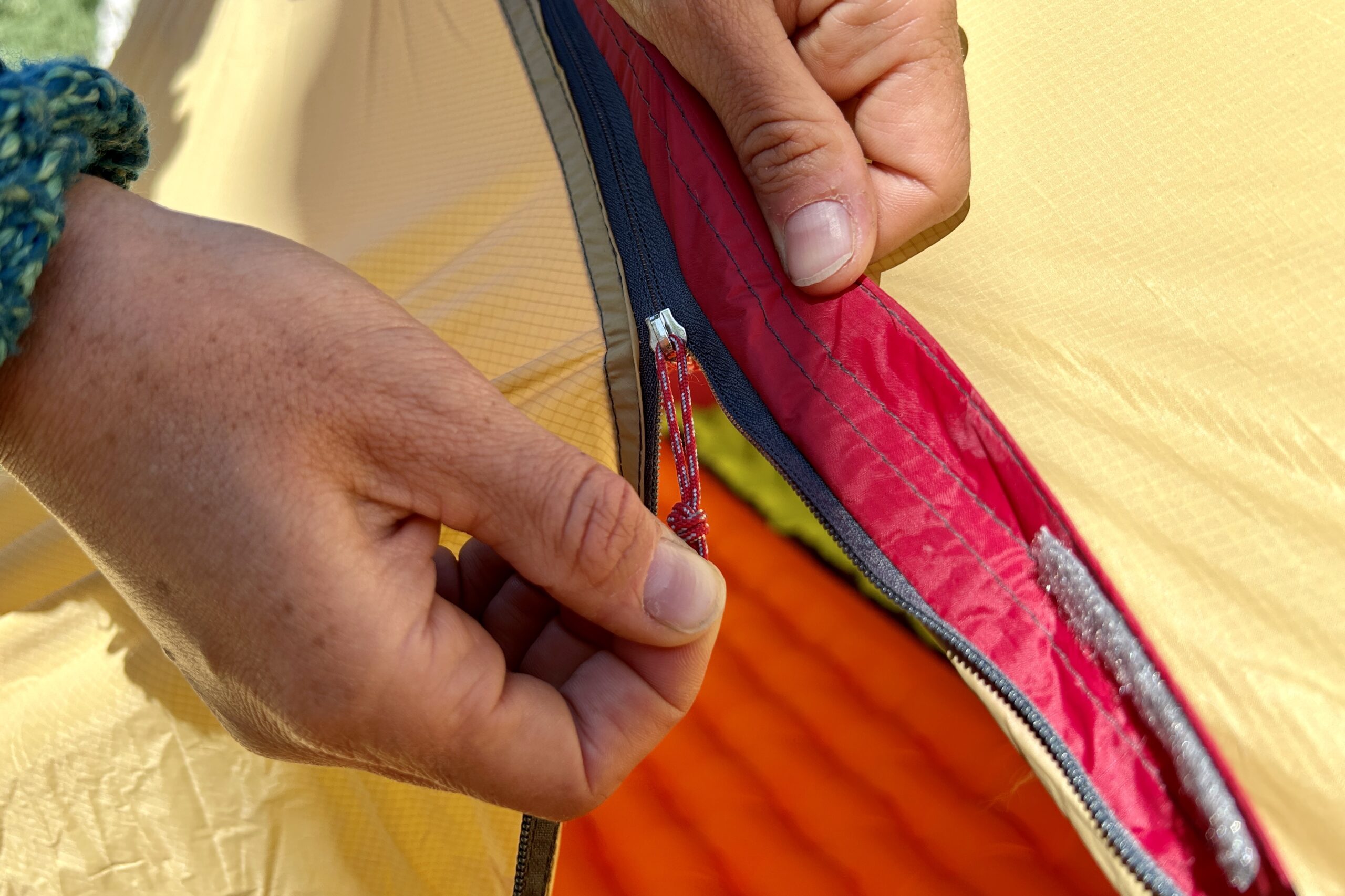 A closeup of a tent rainfly zipper.