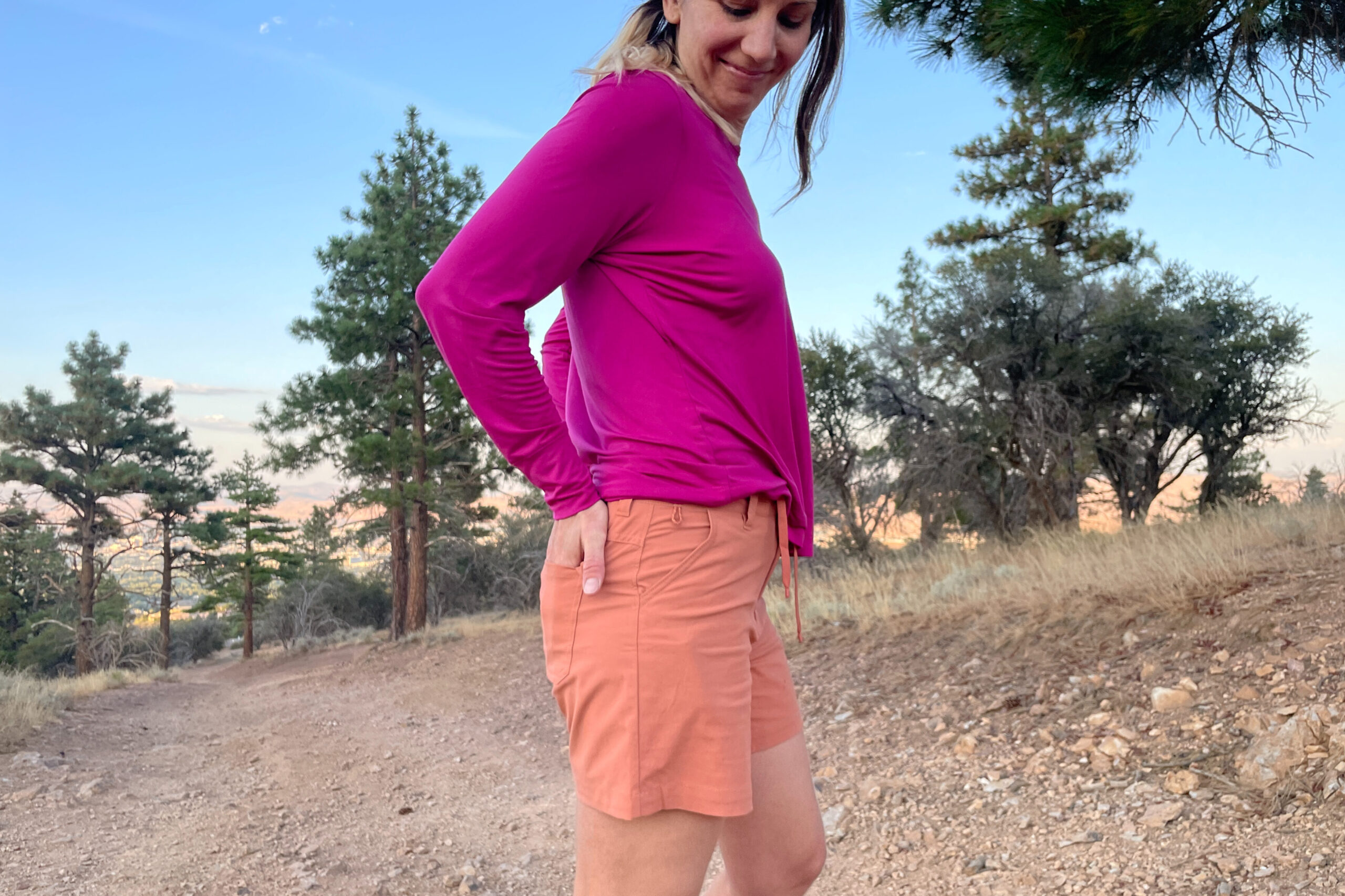 A hiker putting her hands in her hiking shorts back pocket