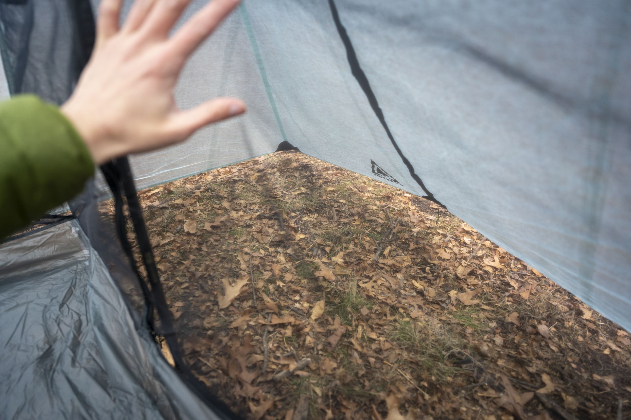 A view into a vestibule of a tent from the interior