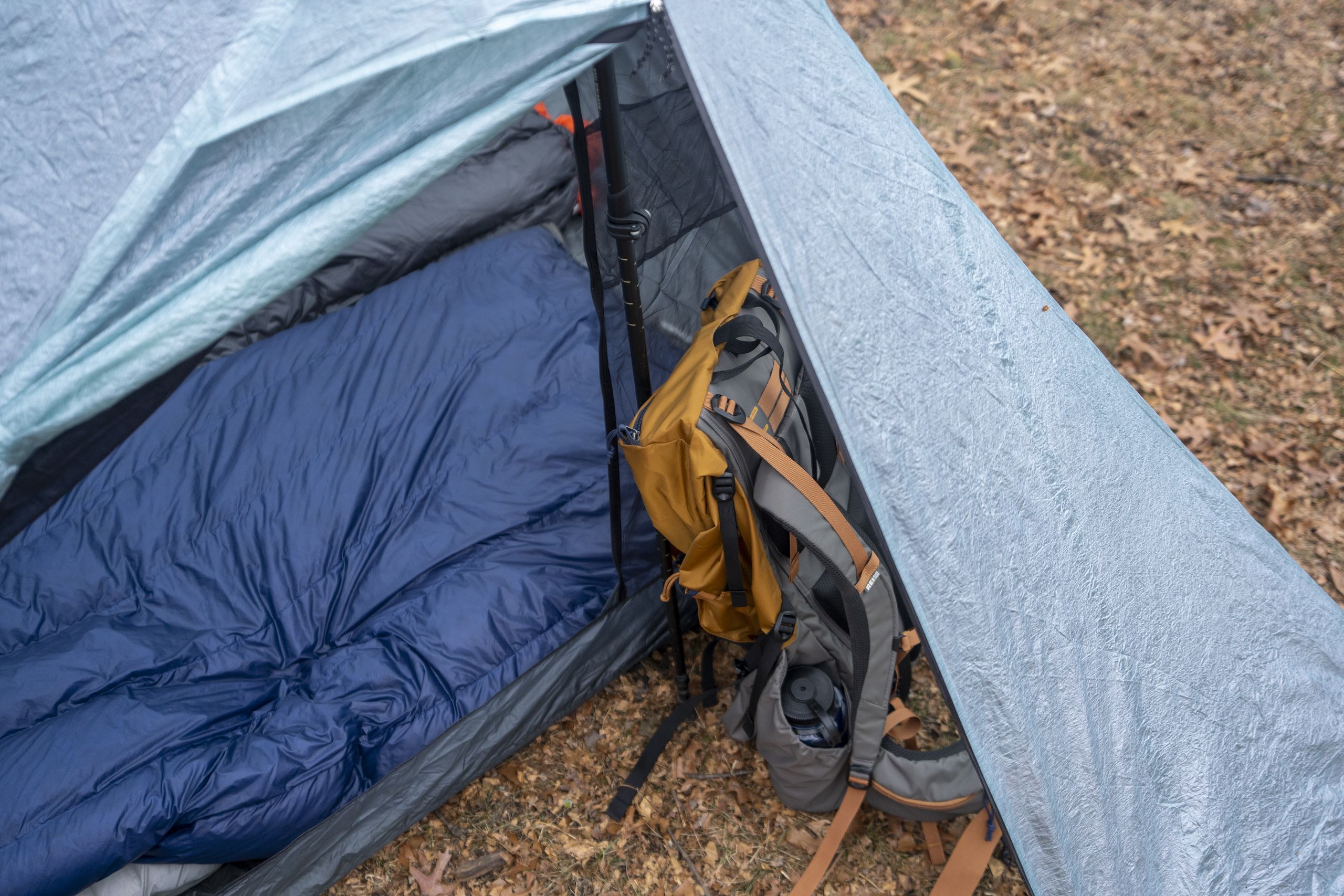 a backpack rests in a tent vestibule