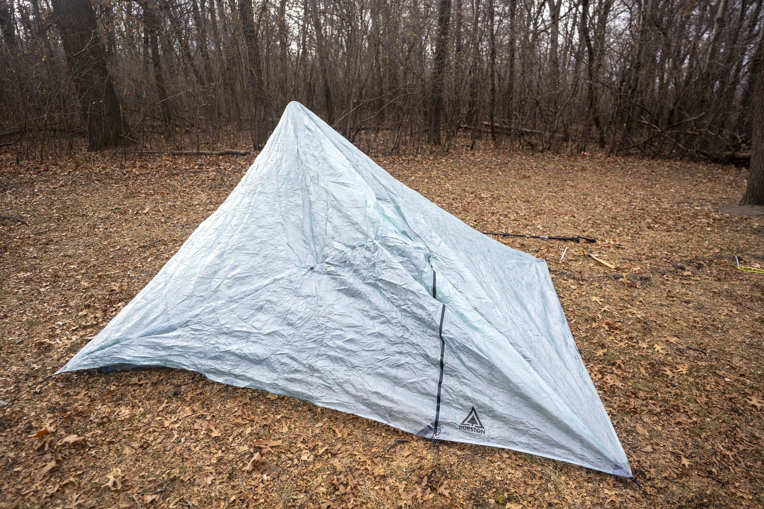 a partially set up trekking pole tent