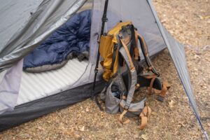 a backpack inside a vestibule of a tent