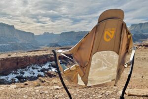 A camping chair from behind in a sunny desert setting.