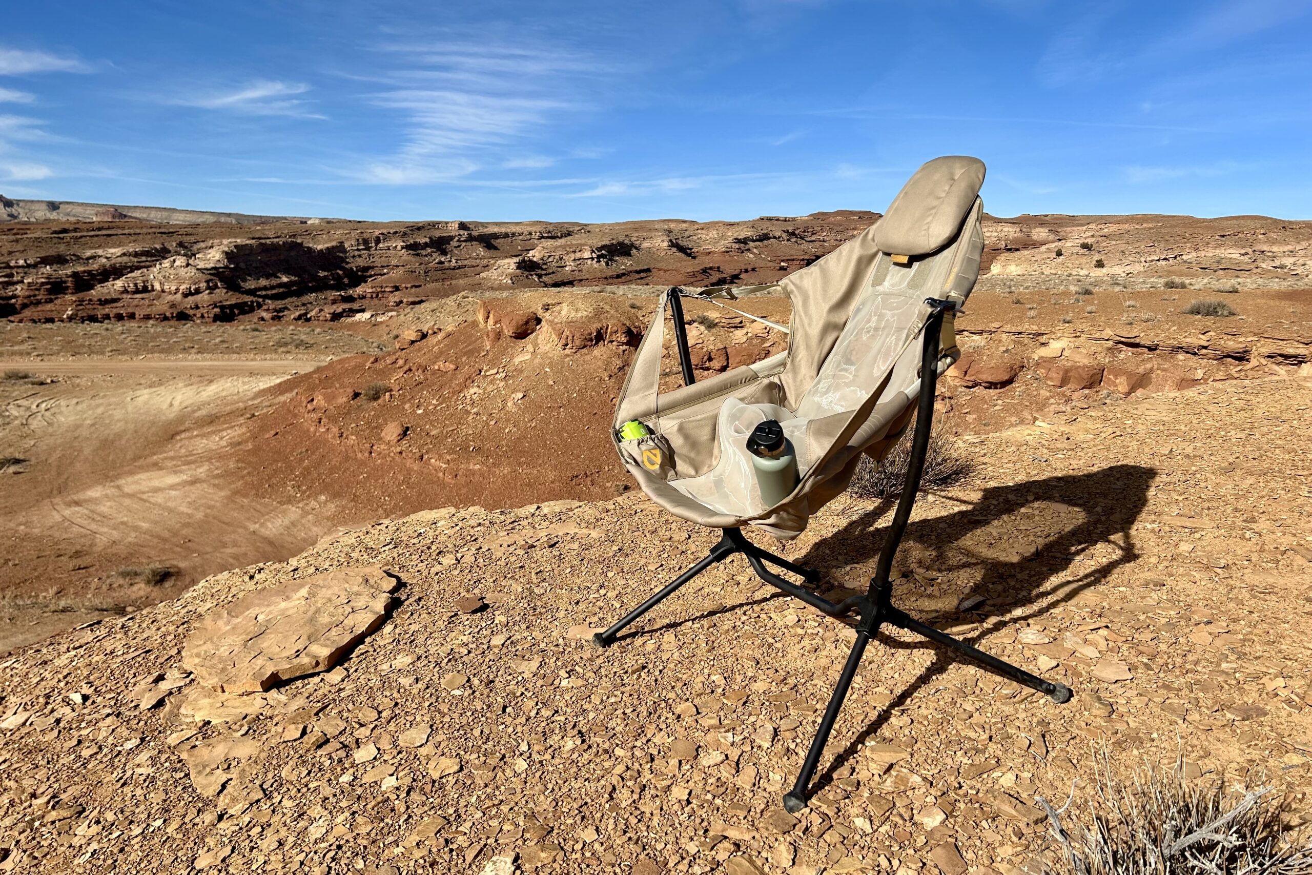 A camping chair in a sunny desert setting.