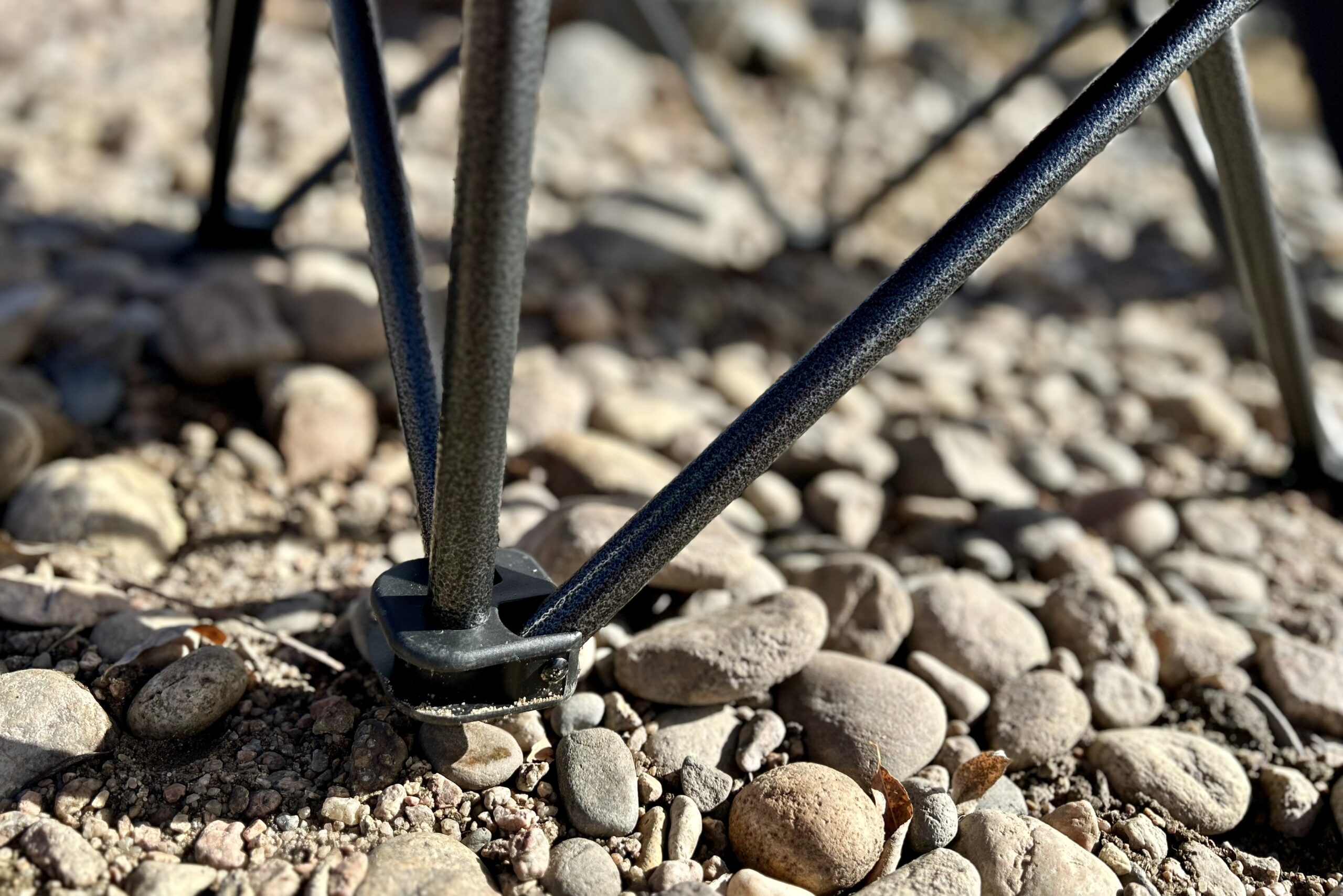 Close up of the metal legs / supports of a camping chair.